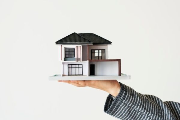 hand-presenting-model-house-home